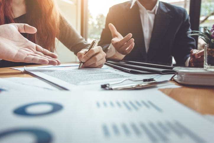 Business professionals reviewing corporate and financial documents