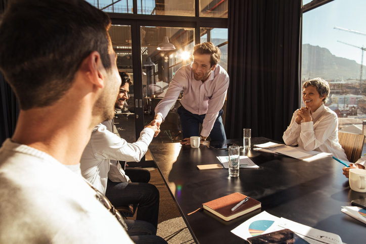 Business owners and advisors discussing the next steps in an Asset Purchase transaction