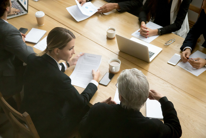Business professionals meeting around a conference table to discuss strategy