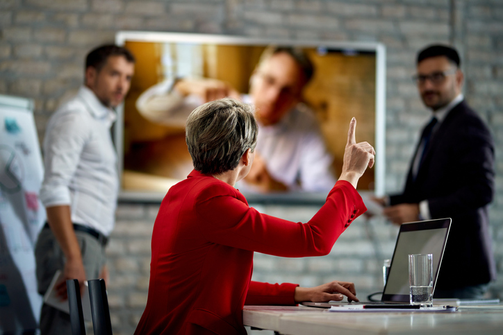 Business professionals addressing a disagreement involving a transaction