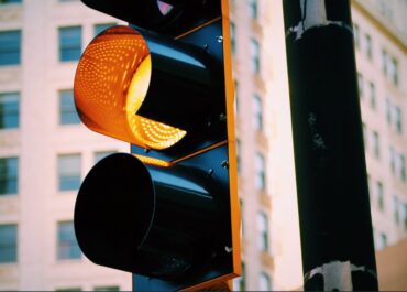 Yellow traffic light at intersection - caution should be exercised before proceeding