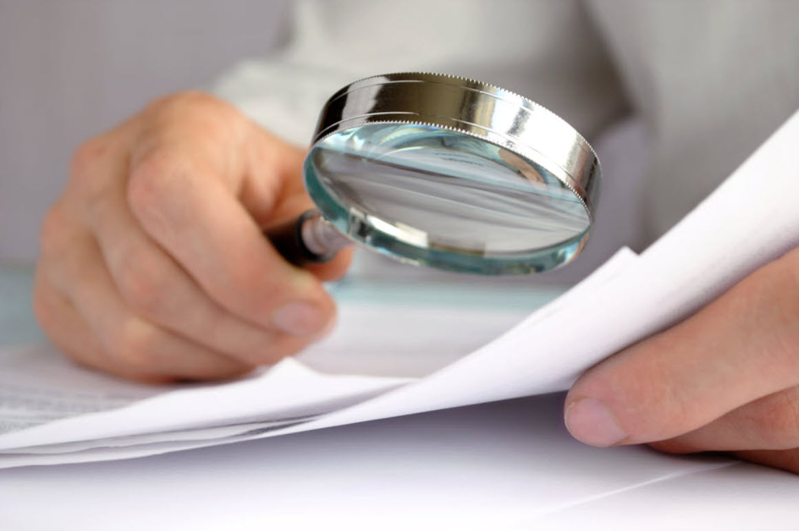 Financial documents being scrutinized before a business acquisition