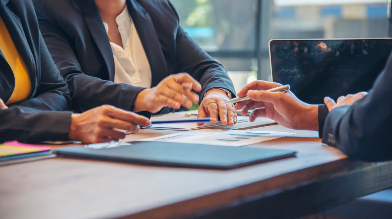 Senior business executives reviewing financial documents and business information