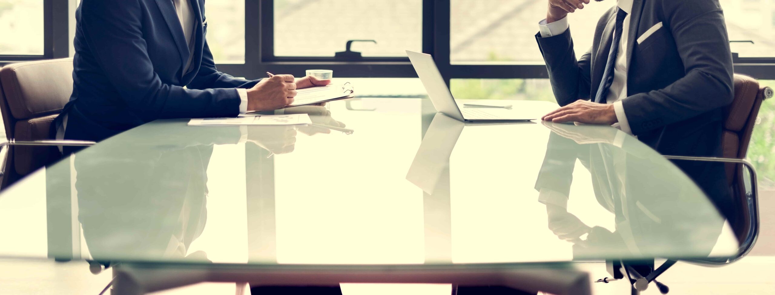 Business professionals meeting at a conference table to discuss a commercial matter